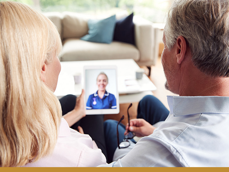 Two people talk with their Care Coordinator virtually.